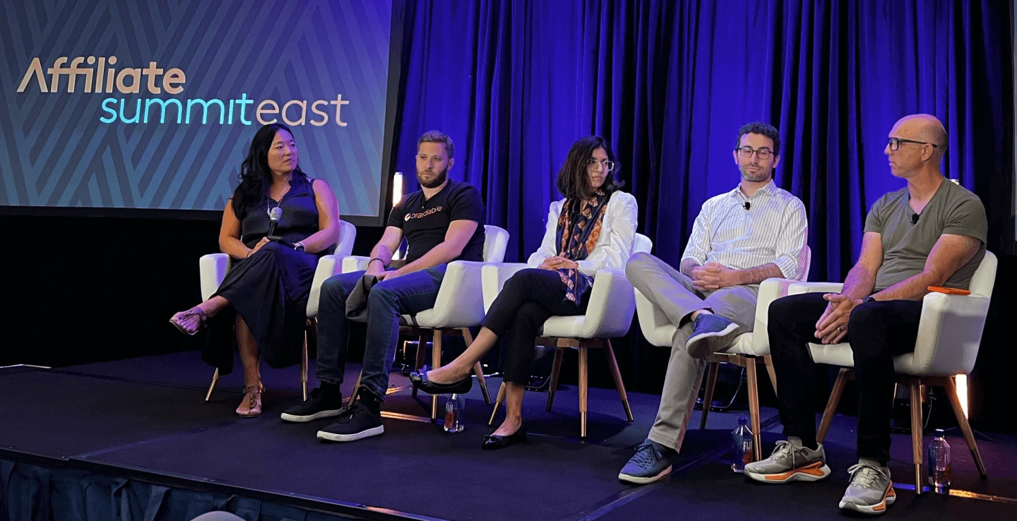 Five panelists seated on stage at Affiliate Summit East