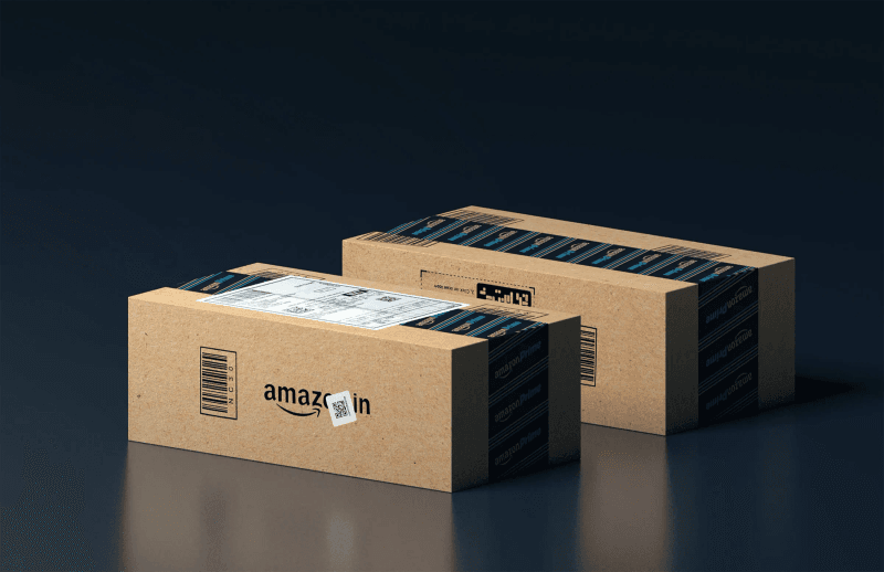 Two Amazon shipping boxes with Prime tape on a dark background